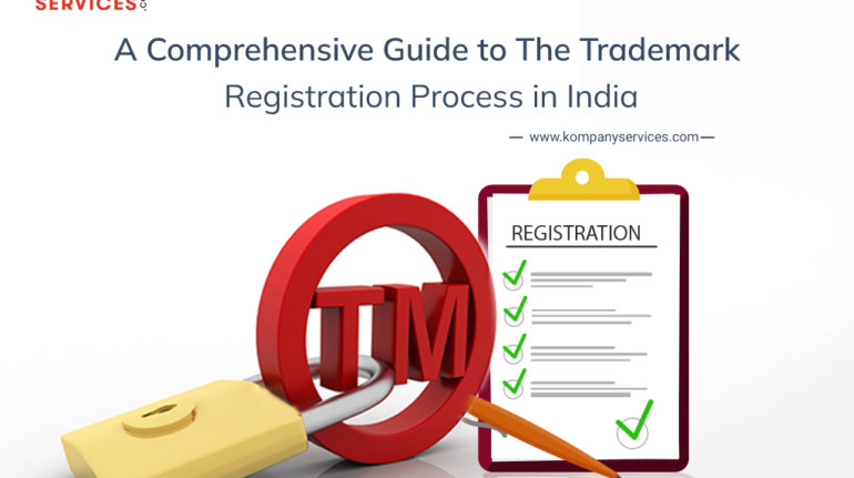 Image showing the text "A Comprehensive Guide to The Trademark Registration Process in India" at the top. Below is a large red 3D 'TM' symbol with a yellow padlock around it, symbolizing protection. A checklist with green checkmarks and an orange check mark is displayed on the right. The website "www.kompanyservices.com" is mentioned.