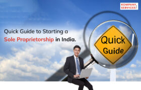 Image of a young man in a business suit sitting and smiling, holding a laptop. The background shows a blue sky with clouds, and a large magnifying glass focusing on a yellow diamond-shaped sign that reads "Quick Guide." The text states, "Quick Guide to Starting a Sole Proprietorship in India." In the top right corner, a logo reads "Kompany Services.