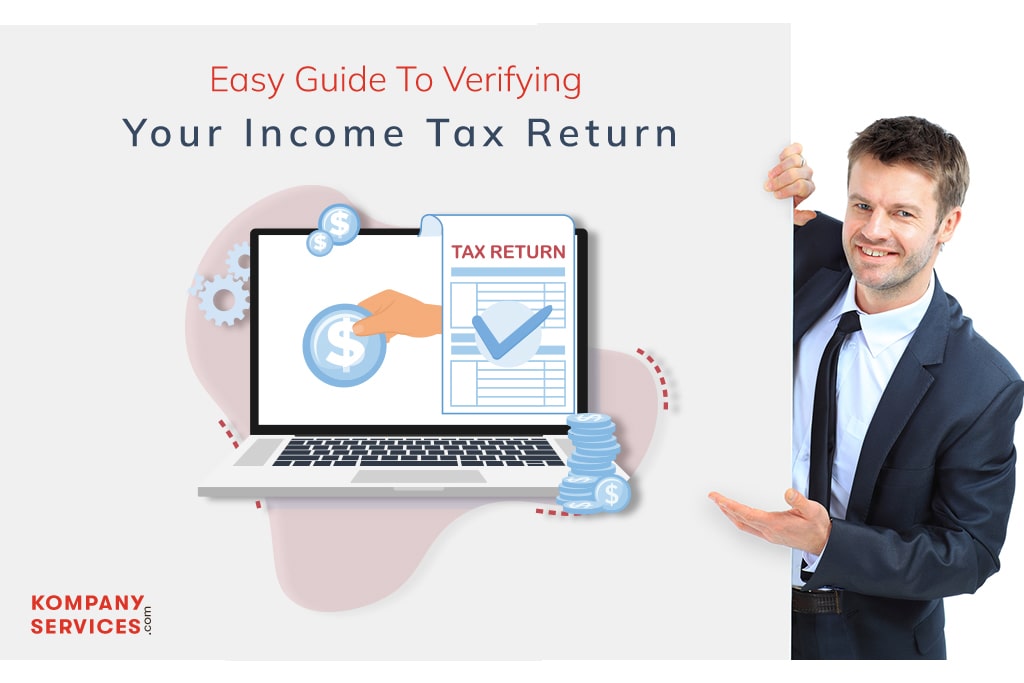 A man in a suit stands next to a poster featuring a laptop displaying a hand with a coin, and an income tax return document. The text reads, “Easy Guide To Verifying Your Income Tax Return.” The company name, "Kompany Services," is in the bottom left corner.