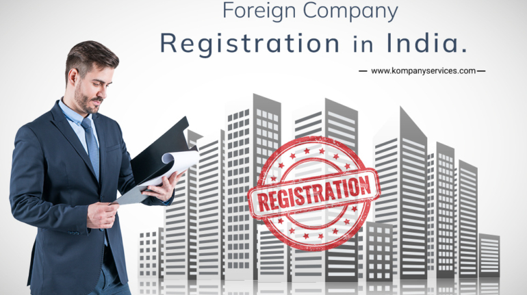 A man in a suit looks at documents while standing in front of a city skyline graphic. The text reads "Foreign Company Registration in India" with a web address below. A red stamp with the word "Registration" is overlaid on the skyline, highlighting the process for a foreign company.